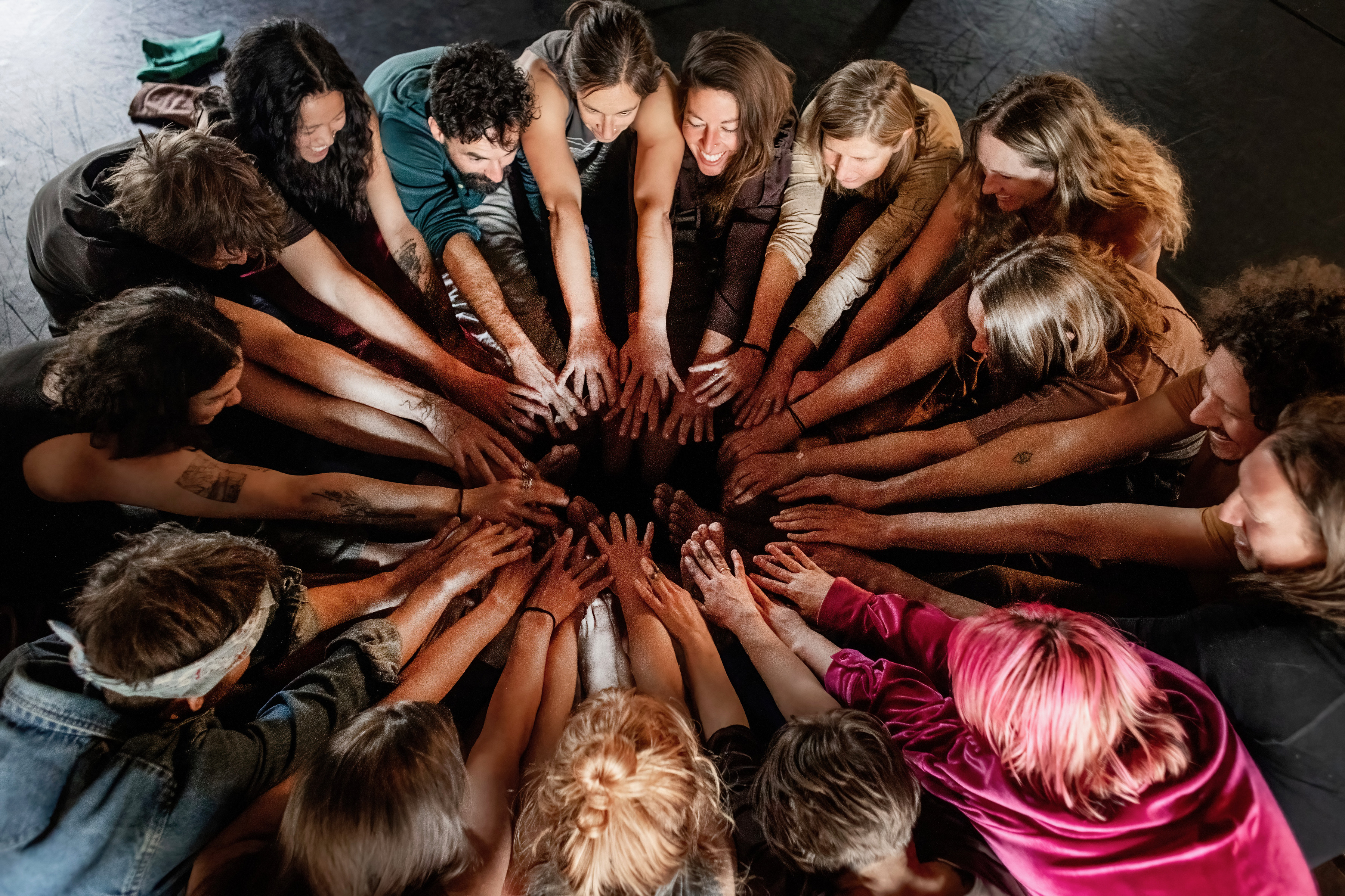 Community hands reaching together in a circle